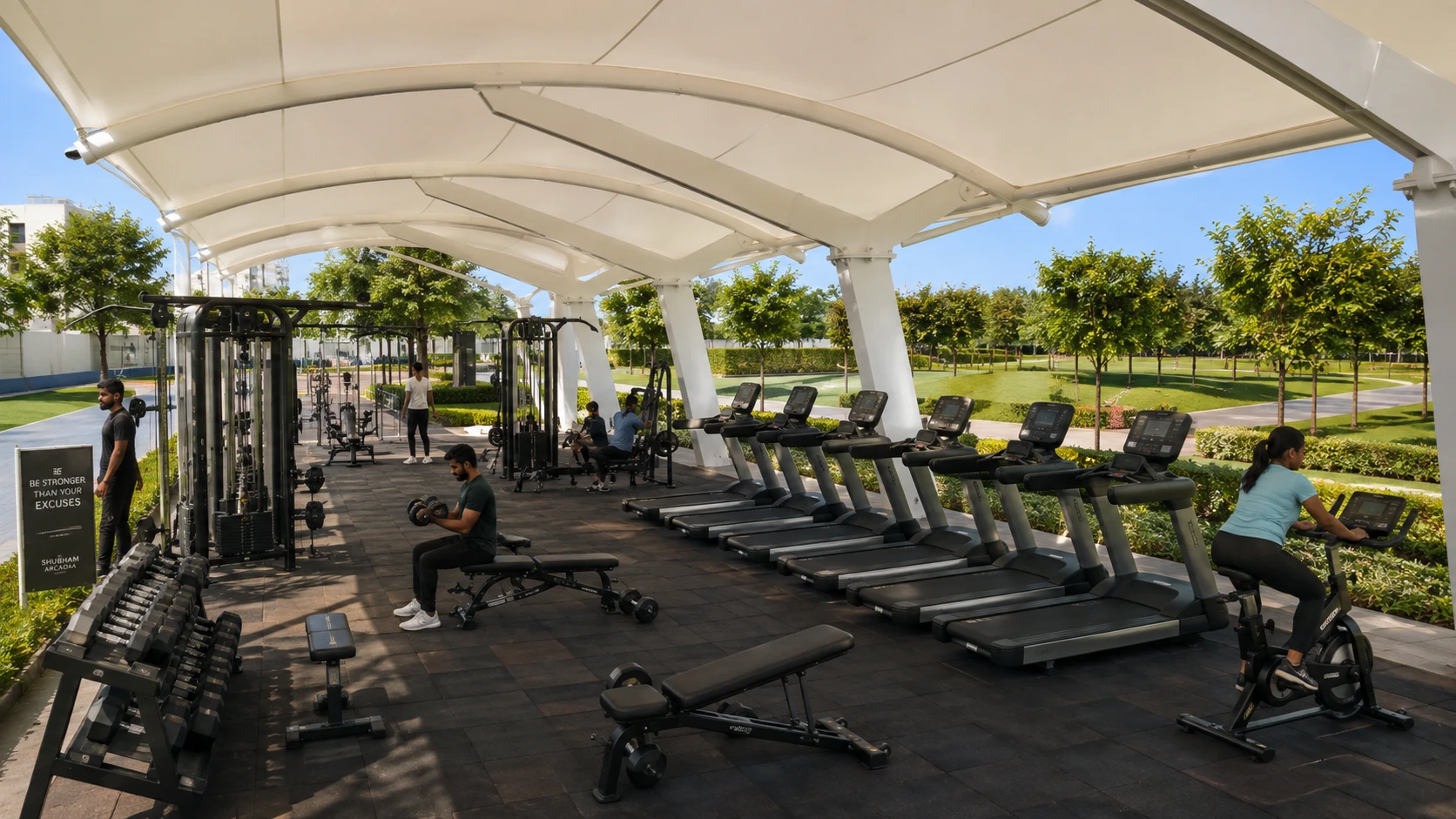 Open-air gym with treadmills and weights under a canopy