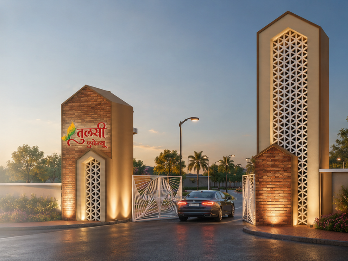 Brick-accented twin gate towers at the entrance of Tulsi Avenue